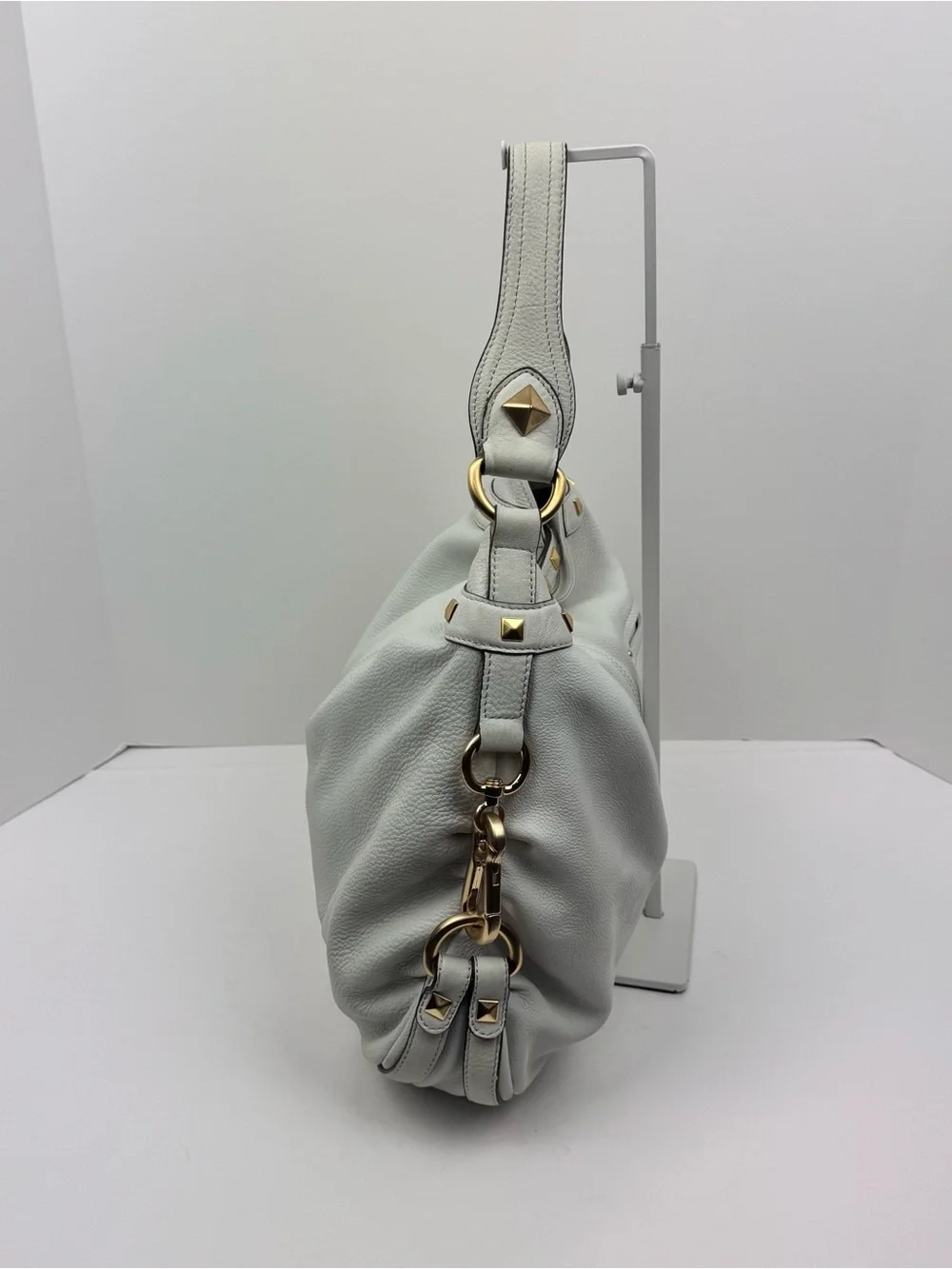 B. Makowsky Leather Ivory Hobo handbag. Gold-tone stud accent hardware.